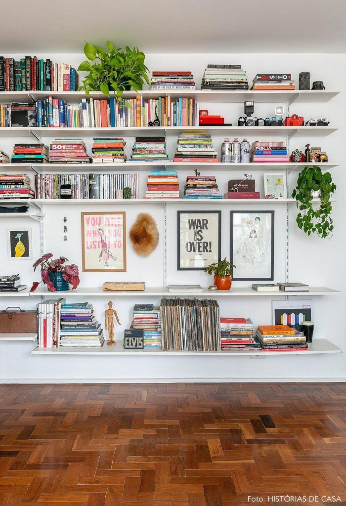 Image of floating shelves for storage. The image show string shelves with book, decor, plants and organization.